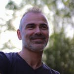 A cheerful man enjoys a sunny day outdoors in Braga, Portugal.